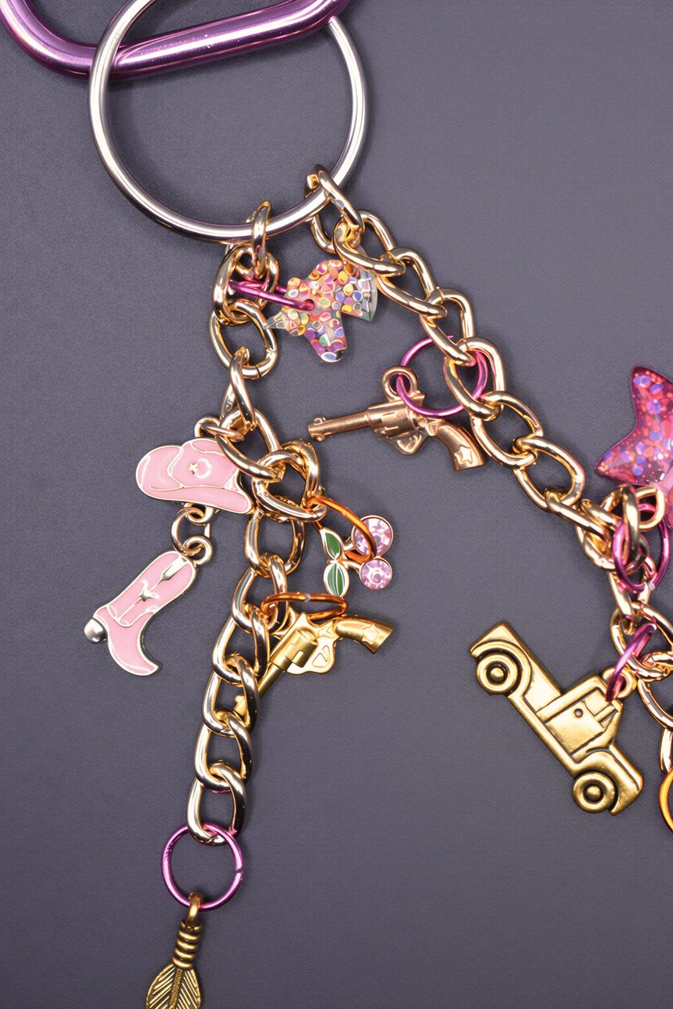Handmade charms laid out charm bar style — the bag charm bar collection you pick from